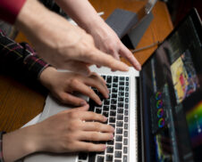 friendly team making movie using a laptop, videoediting process